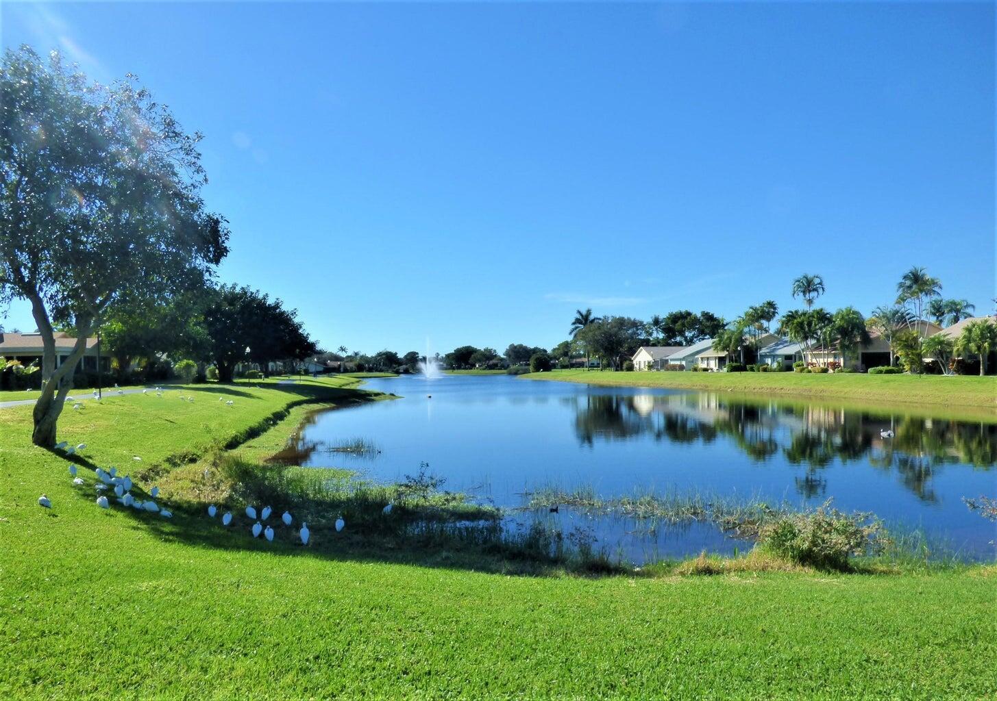 2686 Northwest 7th Court, Unit C Delray Beach, FL 33445 - Photo 32 of 33 a view of a lake with houses in the back