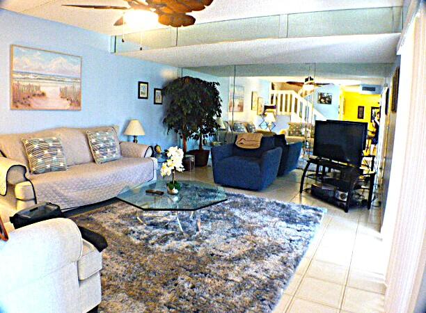2686 Northwest 7th Court, Unit C Delray Beach, FL 33445 - Photo 7 of 33 a living room with furniture and a dining table with wooden floor