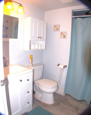 a white toilet sitting next to a bathroom sink and tub