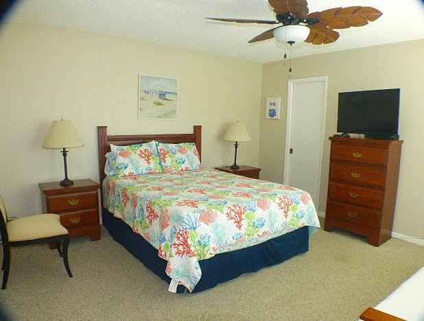 2686 Northwest 7th Court, Unit C Delray Beach, FL 33445 - Photo 9 of 33 a bedroom with a bed and a chandelier