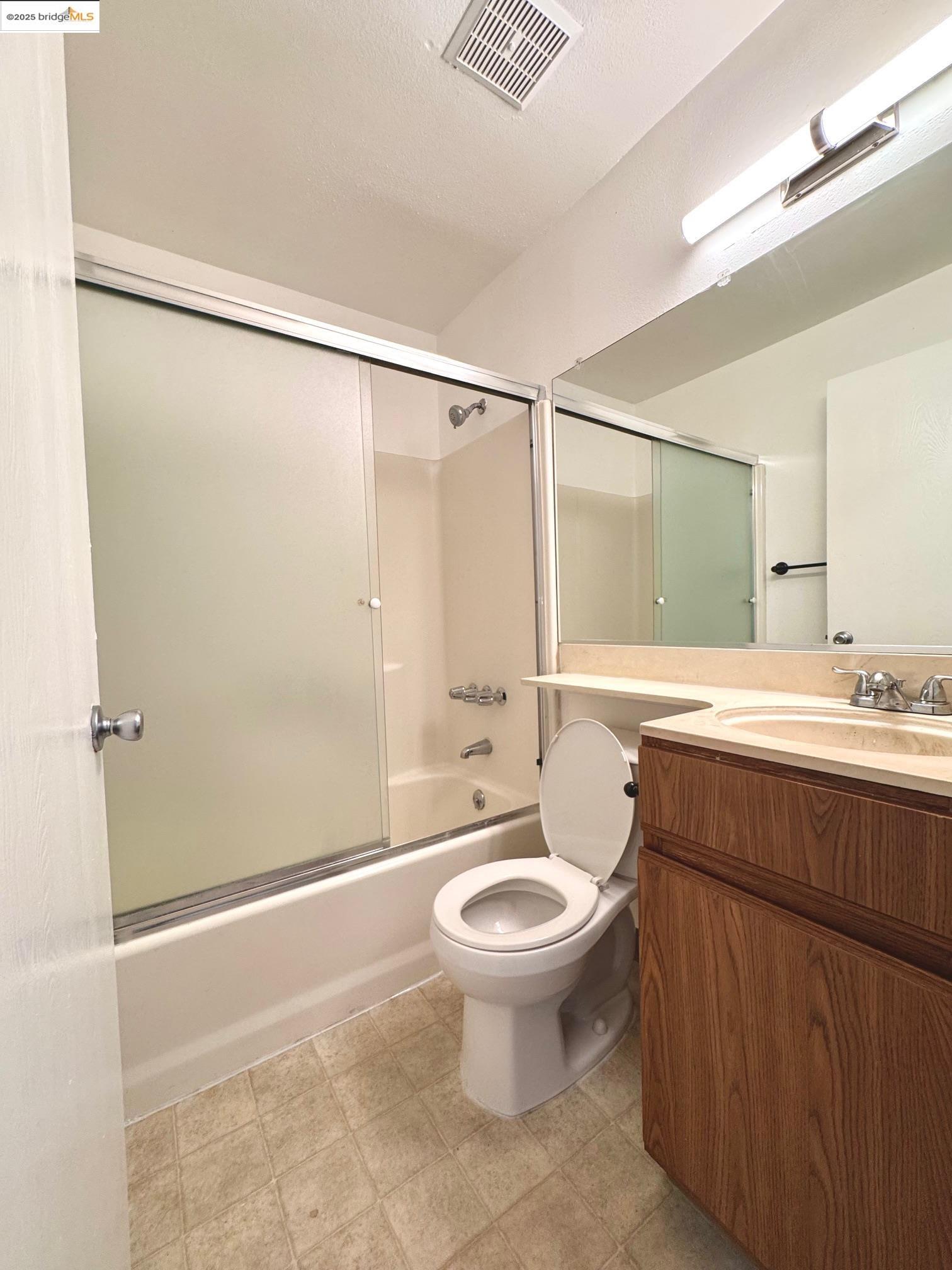 554 Bancroft Avenue, Unit 101 San Leandro, CA 94577 - Photo 15 of 17 a bathroom with a sink toilet and shower