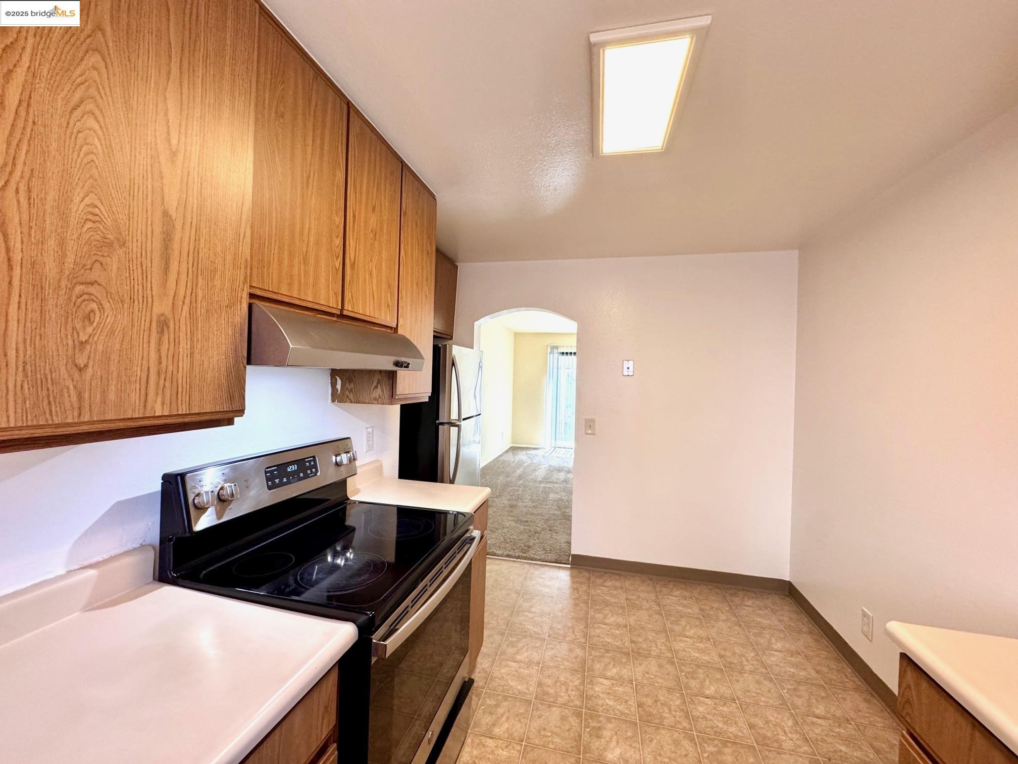 554 Bancroft Avenue, Unit 101 San Leandro, CA 94577 - Photo 4 of 17 a kitchen with a stove and a microwave