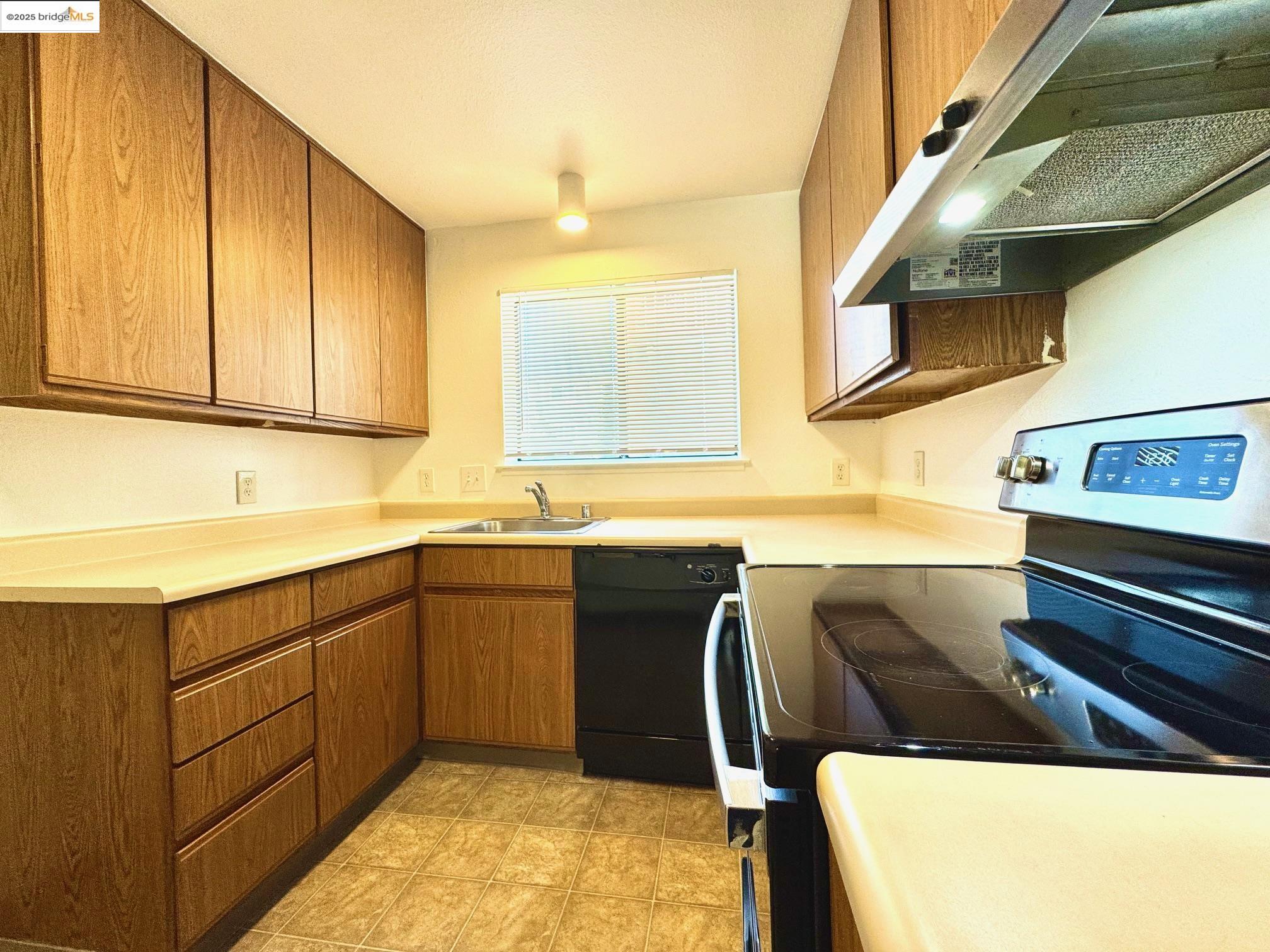 554 Bancroft Avenue, Unit 101 San Leandro, CA 94577 - Photo 5 of 17 a kitchen with stainless steel appliances granite countertop a sink and cabinets