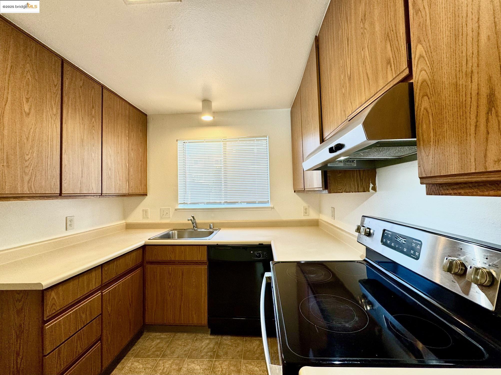 554 Bancroft Avenue, Unit 101 San Leandro, CA 94577 - Photo 6 of 17 a kitchen with a sink stove and cabinets