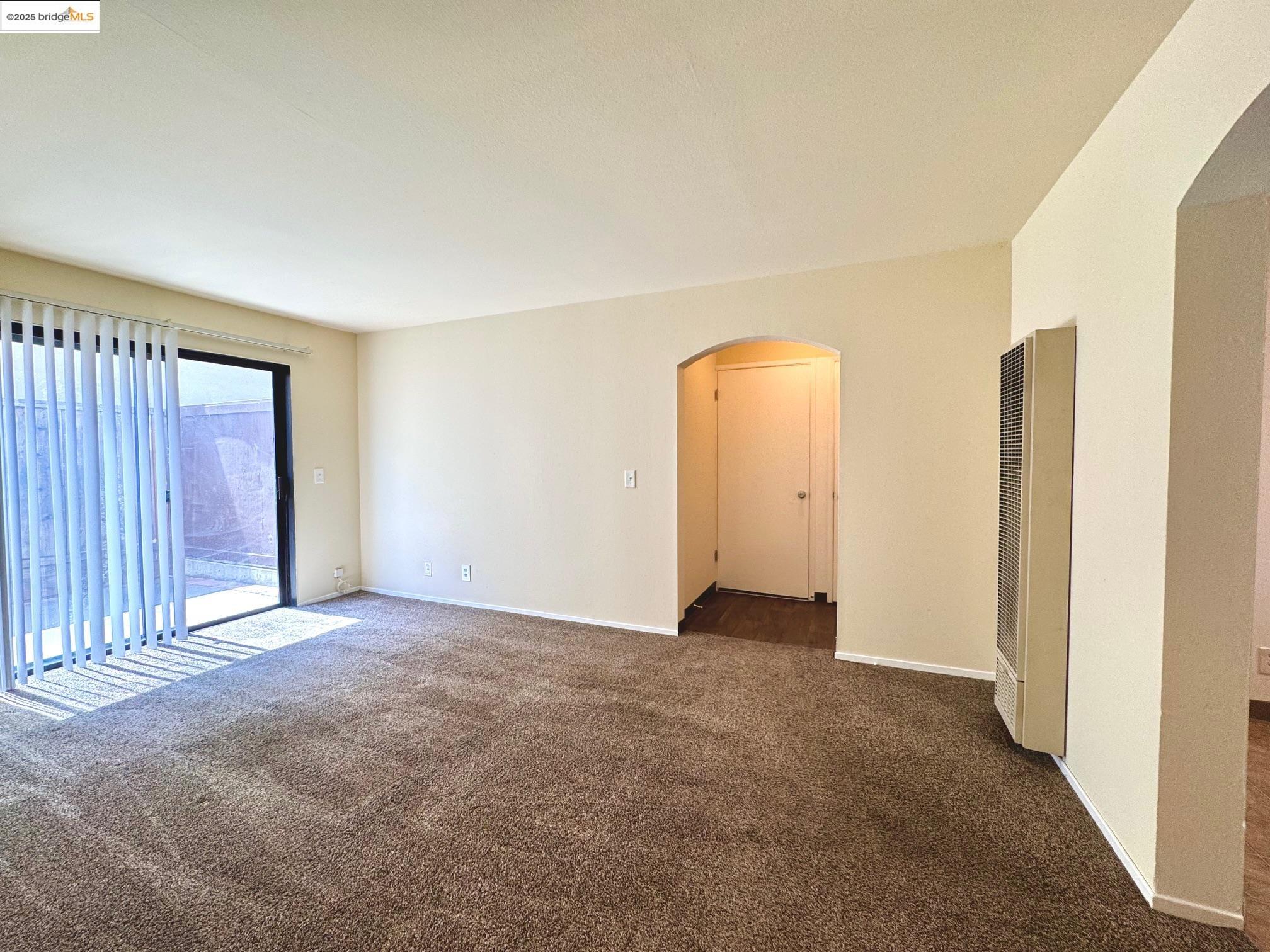 554 Bancroft Avenue, Unit 101 San Leandro, CA 94577 - Photo 7 of 17 an empty room with windows