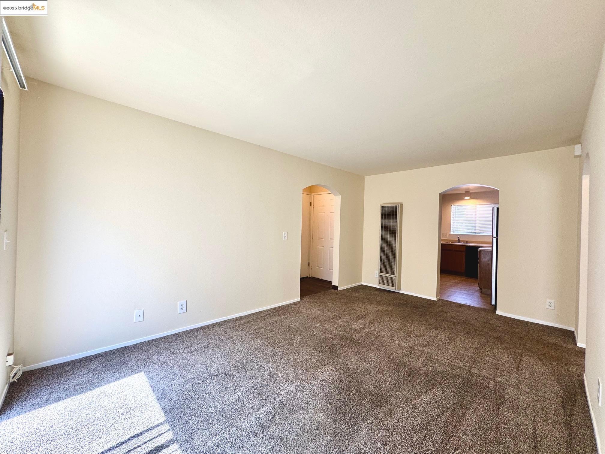 554 Bancroft Avenue, Unit 101 San Leandro, CA 94577 - Photo 10 of 17 a view of an empty room with a fireplace