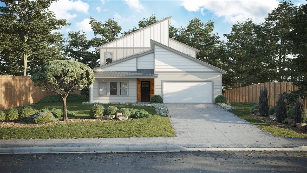a front view of a house with a garden and trees