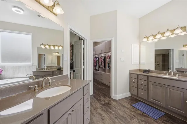 a bathroom with a double vanity sink and a mirror