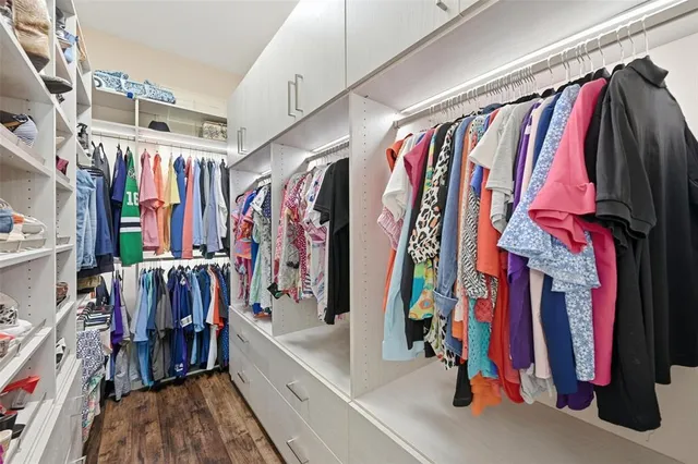 a view of walk in closet with clothes