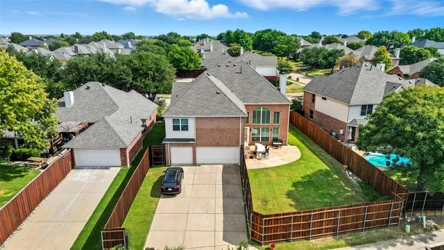 an aerial view of a house with garden space and street view