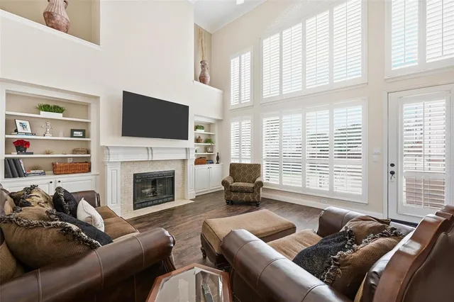 a living room with furniture a fireplace and a flat screen tv