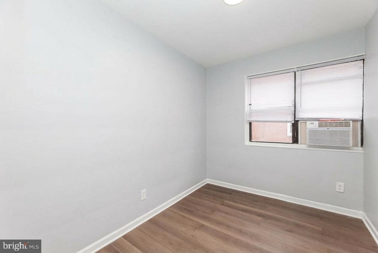2100 Channing Street Northeast, Unit 2C Washington, DC 20018 - Photo 2 of 9 a view of an empty room with wooden floor and a window
