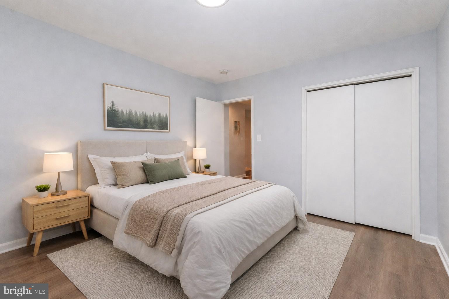 2100 Channing Street Northeast, Unit 2C Washington, DC 20018 - Photo 3 of 9 a bedroom with a bed and a painting on the wall