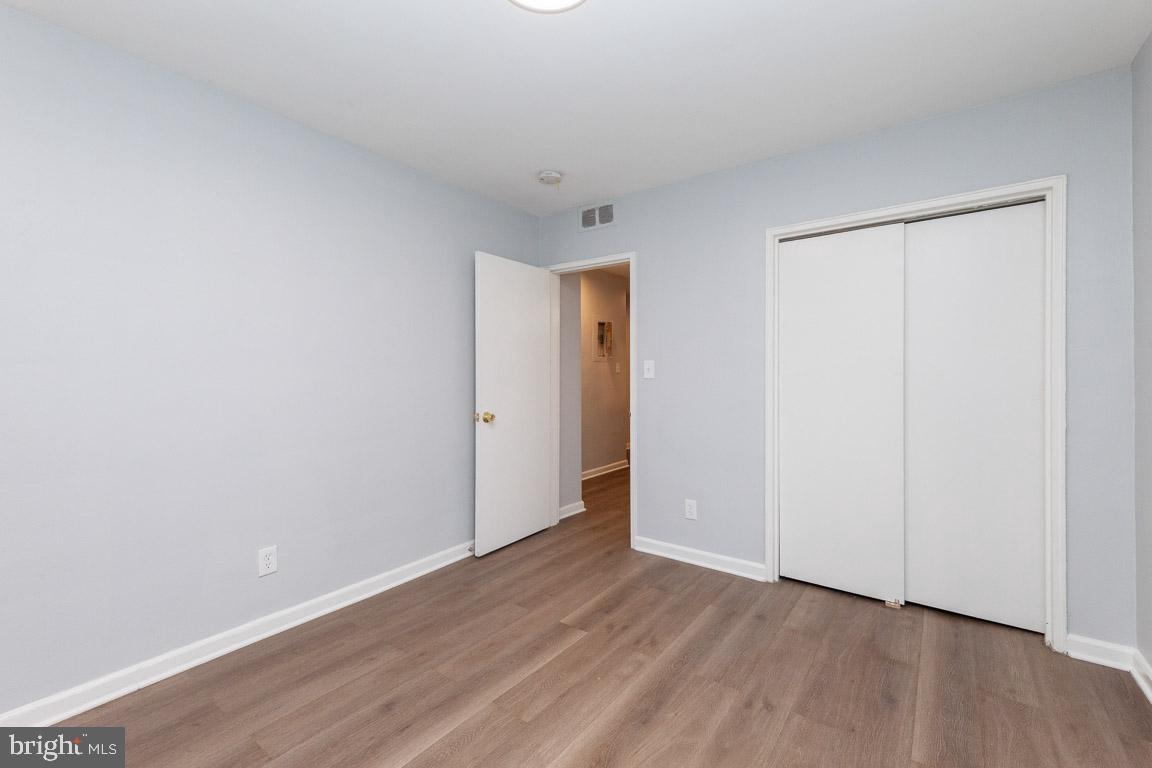 2100 Channing Street Northeast, Unit 2C Washington, DC 20018 - Photo 4 of 9 a view of an empty room with wooden floor and closet