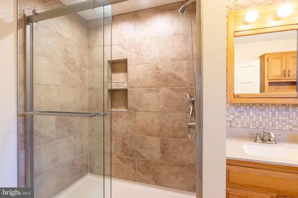 a bathroom with a sink toilet and a mirror