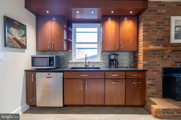 a metallic refrigerator freezer and a stove sitting inside of a kitchen