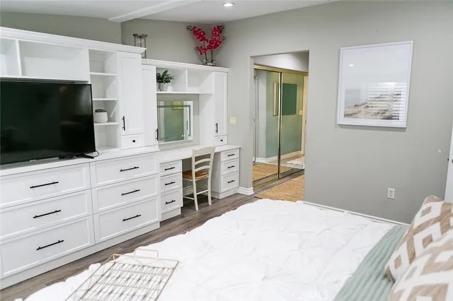a spacious bedroom with a bed and flat screen tv