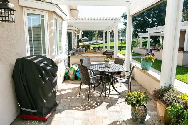a view of a patio with table and chairs potted plants