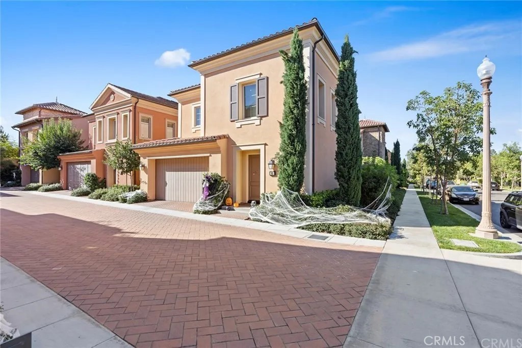 a front view of a house with garden and plants