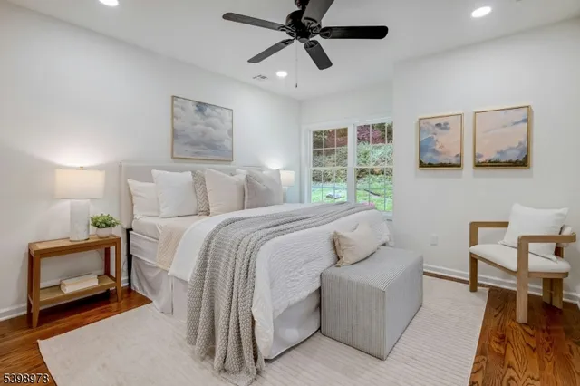 a spacious bathroom with a double vanity sink a toilet and a mirror