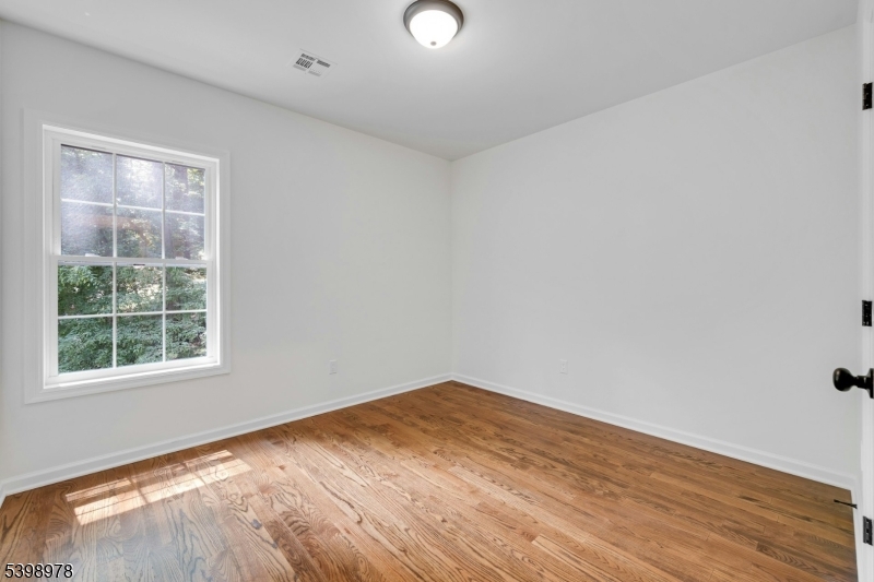26 Woodland Road Morristown, NJ 07960 - Photo 16 of 26 an empty room with wooden floor and windows