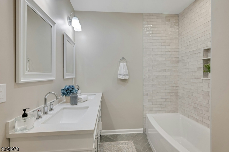 26 Woodland Road Morristown, NJ 07960 - Photo 17 of 26 a bathroom with a sink a bathtub and a mirror