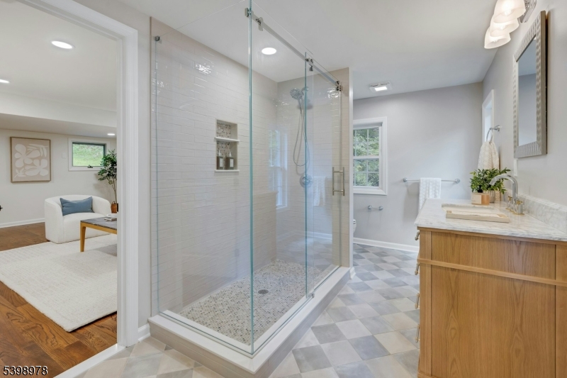 26 Woodland Road Morristown, NJ 07960 - Photo 22 of 26 a bathroom with a shower sink and mirror