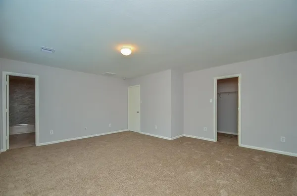a view of an empty room and closet area