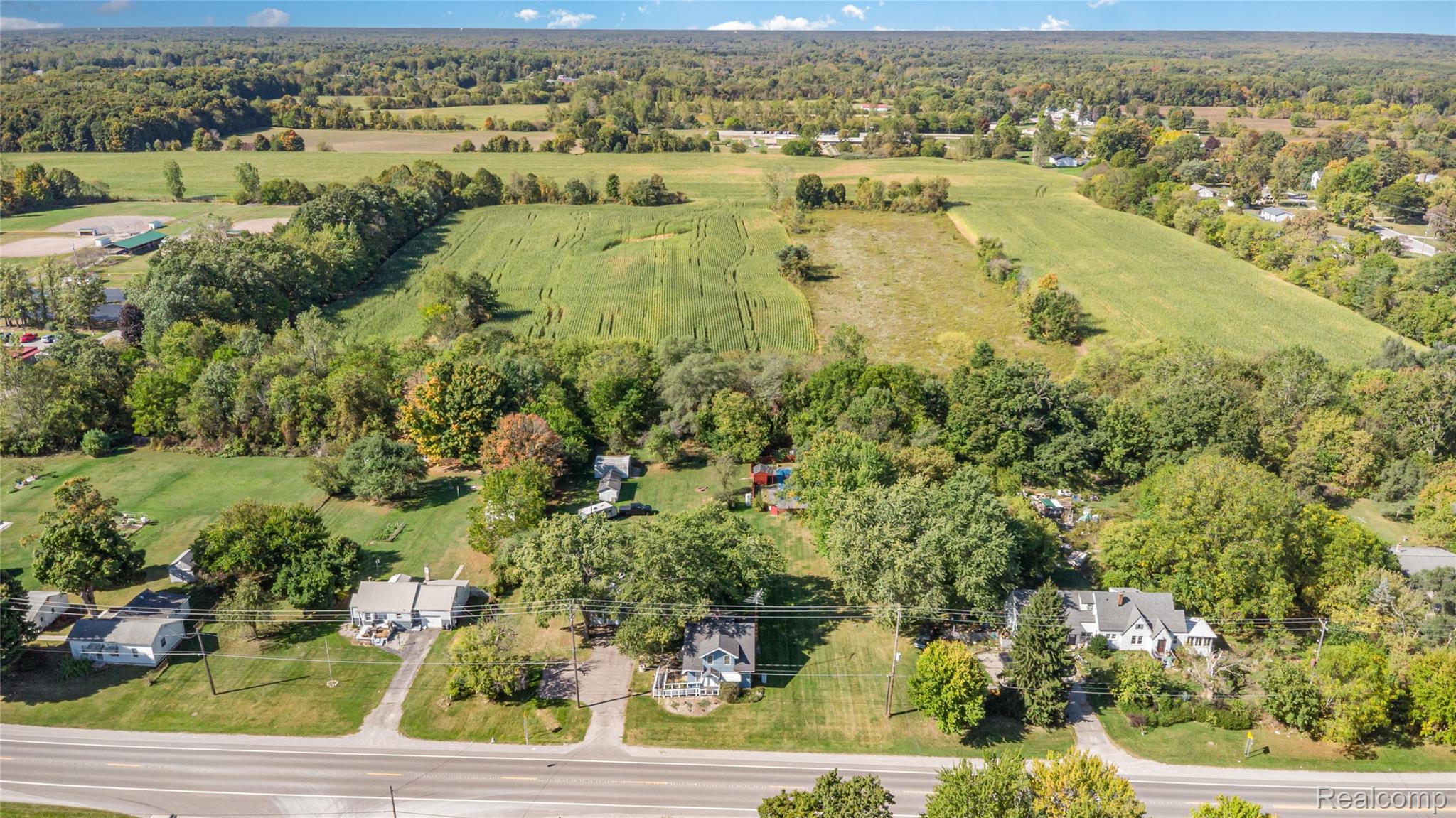 5447 North State Road Davison, MI 48423 - Photo 26 of 29 Aerial view of sparsely populated area featuring a tree filled landscape