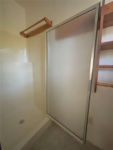 a bathroom with a glass shower door