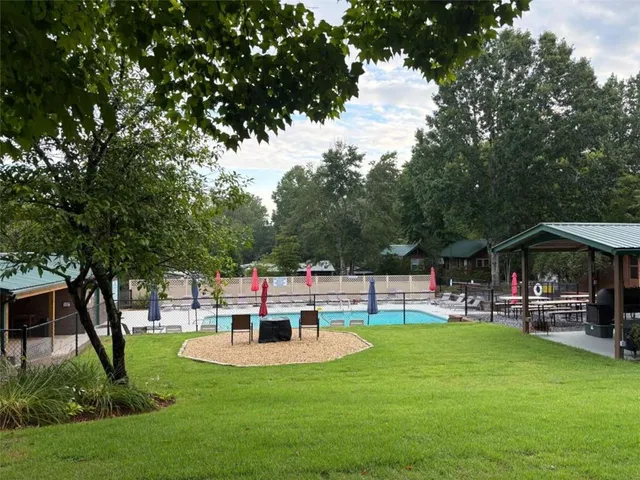 a view of a house with backyard and sitting area