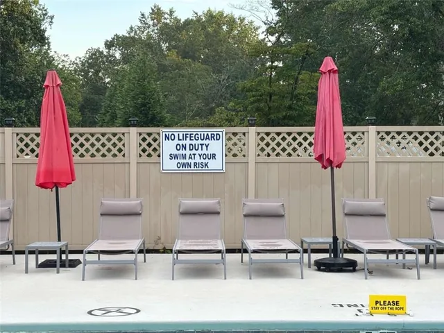 swimming pool with outdoor seating and yard