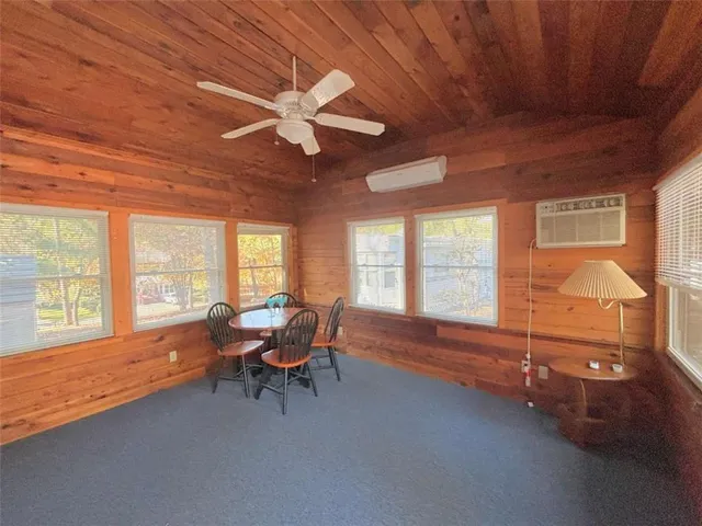 a living room with furniture and large windows