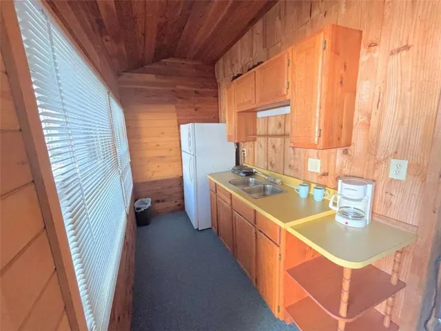 a kitchen with a stove a sink and a refrigerator