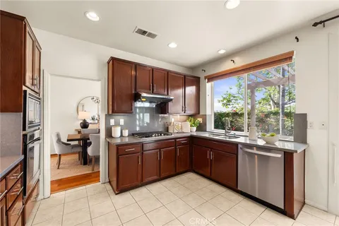 a kitchen with a sink stove and cabinets