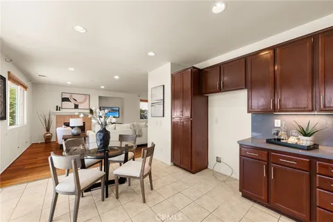 a dining room with furniture and kitchen view