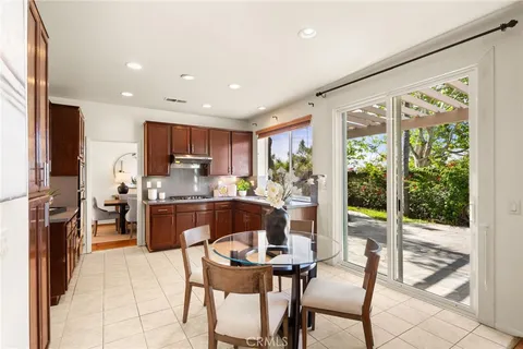 a kitchen with a table chairs refrigerator and microwave