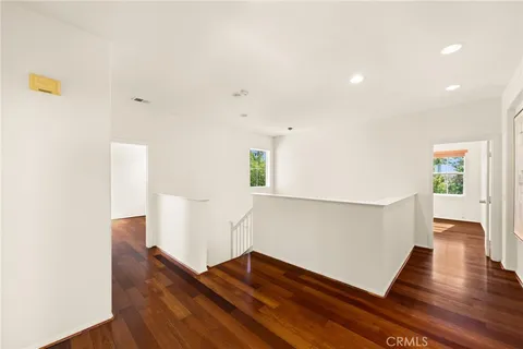 a view of hallway with wooden floor