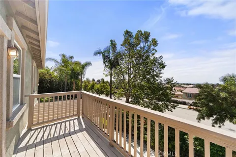 a view of balcony with wooden floor and fence