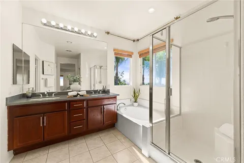 a spacious bathroom with a tub sink shower and mirror