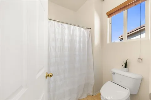 a white toilet sitting next to a shower curtain