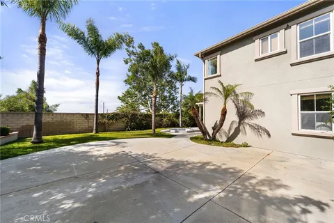 a view of a house with a yard and potted plants