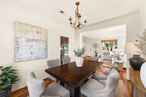 a dining room with furniture and wooden floor