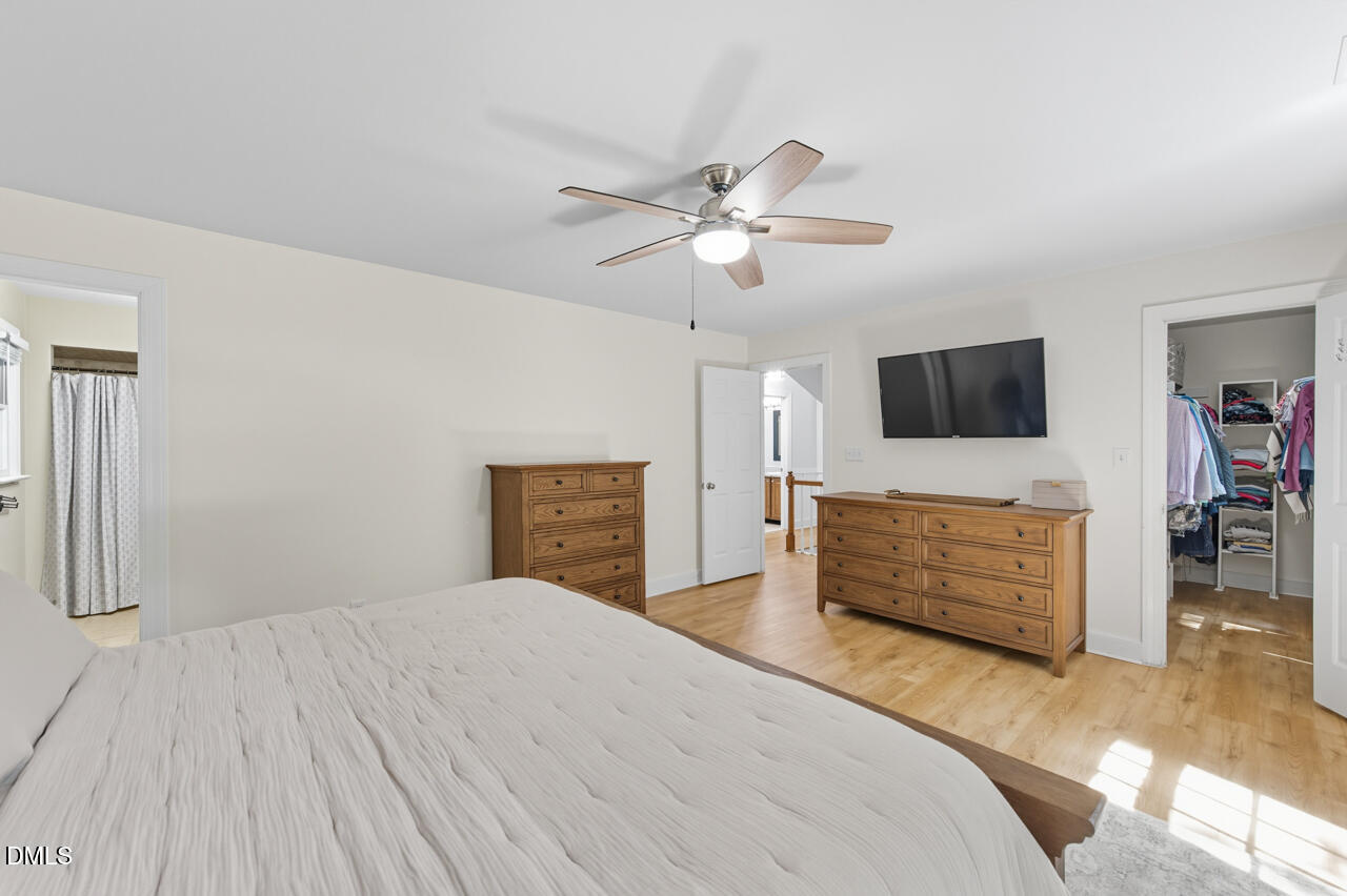 8713 Mourning Dove Road Raleigh, NC 27615 - Photo 22 of 56 a bedroom with a bed and a flat screen tv