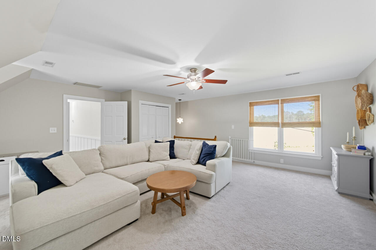 8713 Mourning Dove Road Raleigh, NC 27615 - Photo 35 of 56 a living room with furniture and a large window