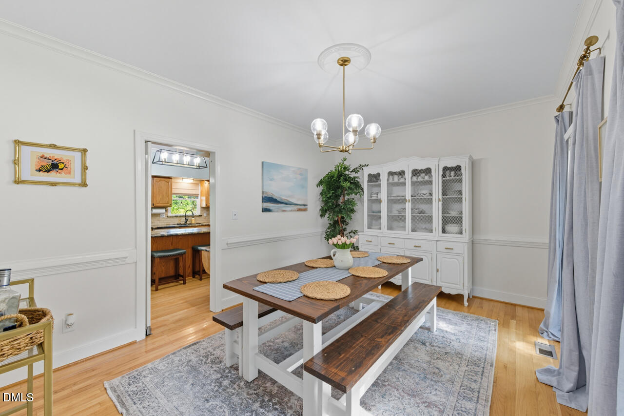 8713 Mourning Dove Road Raleigh, NC 27615 - Photo 5 of 56 a living room with dining table and a wooden floor