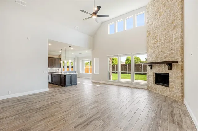 a view of an empty room with a fireplace and a window
