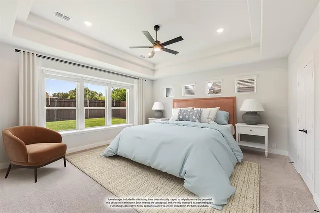 a spacious bedroom with a bed and a couch