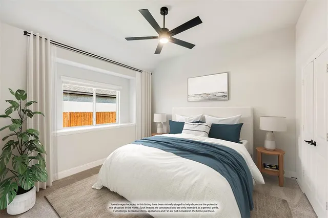 a bedroom with a bed and a potted plant