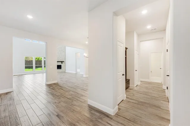 a view of a hallway with wooden floor